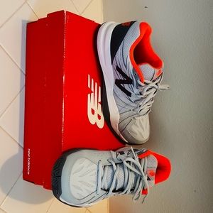 Never worn New Balance all court tennis court shoes. Size 8 B. Grey/ Orange.